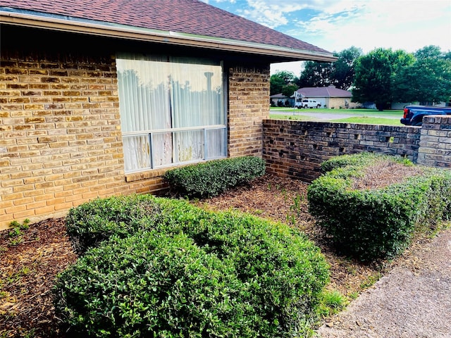 310 Lori Ln, Brownwood, TX 76801 - view of property exterior featuring brick siding and roof with shingles