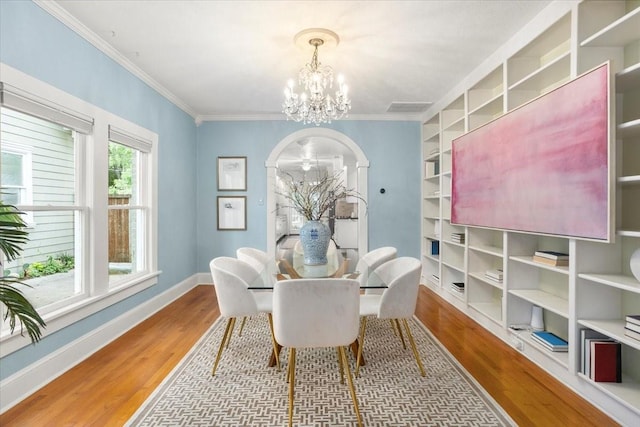 4016 Pershing Ave, Fort Worth, TX 76107 - dining room featuring a chandelier, wood finished floors, baseboards, crown molding, and built in features