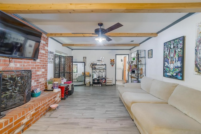 905 E Renfro St, Burleson, TX 76028 - living room with beamed ceiling, wood finished floors, a brick fireplace, and ceiling fan