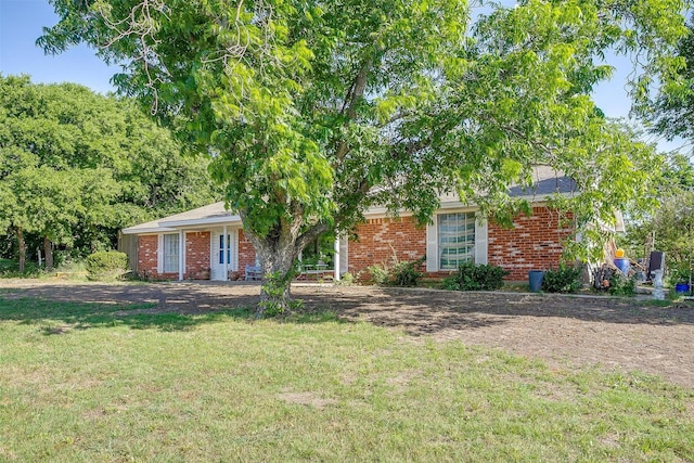 905 E Renfro St, Burleson, TX 76028 - view of front of house featuring a front yard and brick siding