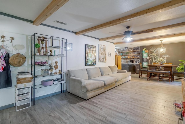 905 E Renfro St, Burleson, TX 76028 - living room with wood finished floors, beam ceiling, ceiling fan, baseboards, and a chandelier