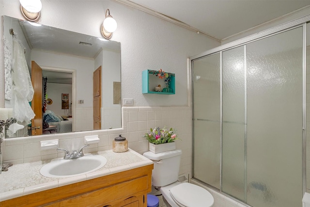 905 E Renfro St, Burleson, TX 76028 - ensuite bathroom with crown molding, vanity, a stall shower, toilet, and tile walls