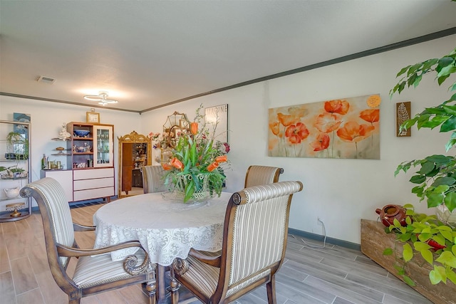 905 E Renfro St, Burleson, TX 76028 - dining space with wood tiled floors, ornamental molding, and baseboards