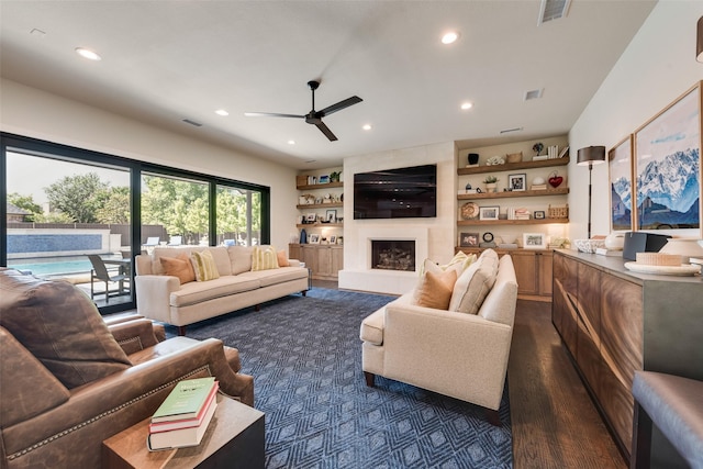 11807 Capitan Ln, Frisco, TX 75033 - living room featuring recessed lighting, ceiling fan, a fireplace, dark wood-style floors, and built in features