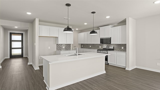 1632 Elle Ln, Aubrey, TX 76227 - kitchen featuring stainless steel range with gas stovetop, a sink, baseboards, a center island with sink, and white cabinetry