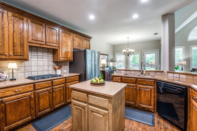 7201 Faraday Ln, Mckinney, TX 75071 - kitchen featuring black dishwasher, a sink, freestanding refrigerator, dark wood-style floors, and backsplash