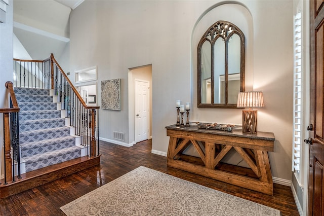 7201 Faraday Ln, Mckinney, TX 75071 - entryway with dark wood-type flooring, baseboards, stairs, a towering ceiling, and arched walkways