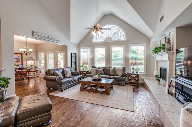 7201 Faraday Ln, Mckinney, TX 75071 - living room with plenty of natural light, ceiling fan, a glass covered fireplace, wood finished floors, and high vaulted ceiling