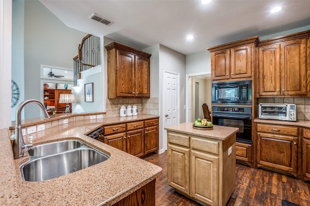 7201 Faraday Ln, Mckinney, TX 75071 - kitchen with black appliances, a sink, light stone counters, backsplash, and recessed lighting
