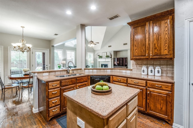 7201 Faraday Ln, Mckinney, TX 75071 - kitchen with a sink, black dishwasher, brown cabinets, vaulted ceiling, and recessed lighting