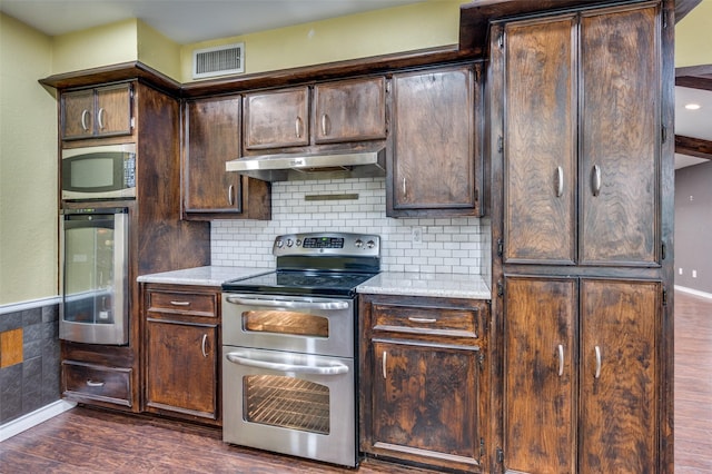 10118 Cromwell Dr, Dallas, TX 75229 - kitchen featuring under cabinet range hood, stainless steel appliances, beverage cooler, dark wood-style flooring, and dark brown cabinetry