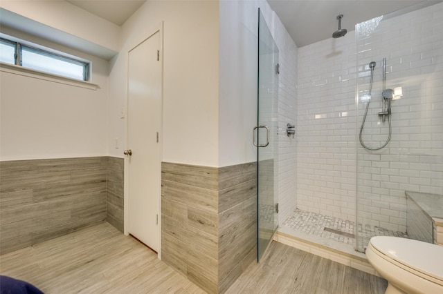 10118 Cromwell Dr, Dallas, TX 75229 - bathroom with tile walls, a stall shower, toilet, and wainscoting