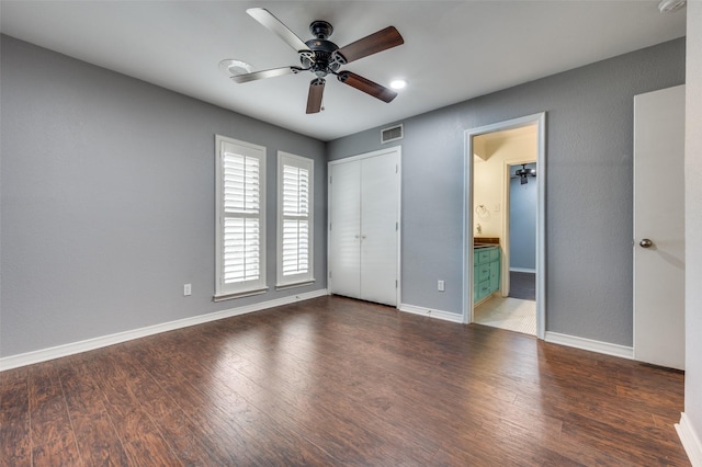 10118 Cromwell Dr, Dallas, TX 75229 - unfurnished bedroom with wood finished floors, baseboards, connected bathroom, and ceiling fan