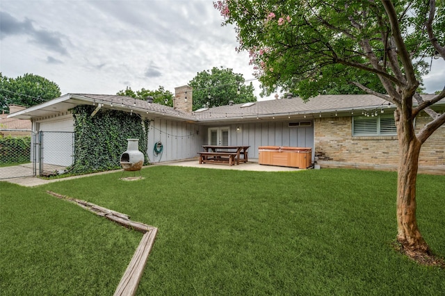 10118 Cromwell Dr, Dallas, TX 75229 - rear view of property featuring a hot tub, a chimney, a patio area, a garage, and brick siding