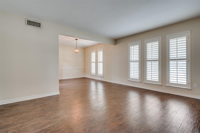 10118 Cromwell Dr, Dallas, TX 75229 - spare room with a chandelier, dark wood finished floors, and baseboards