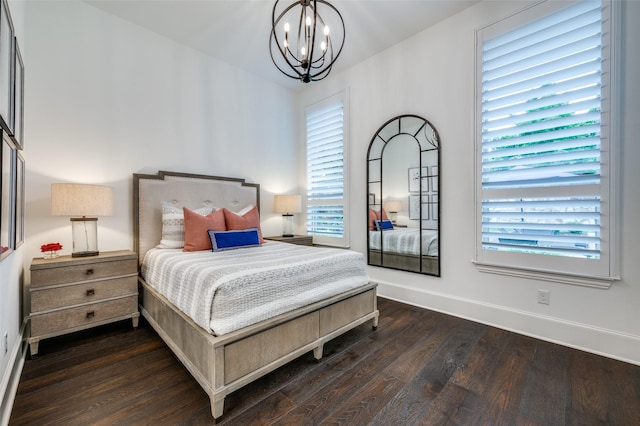 2021 Longmont Ln, Prosper, TX 75078 - bedroom featuring a chandelier, dark wood-style floors, and baseboards
