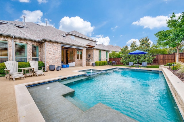 2021 Longmont Ln, Prosper, TX 75078 - view of pool with a patio area, a fenced backyard, and a pool with connected hot tub