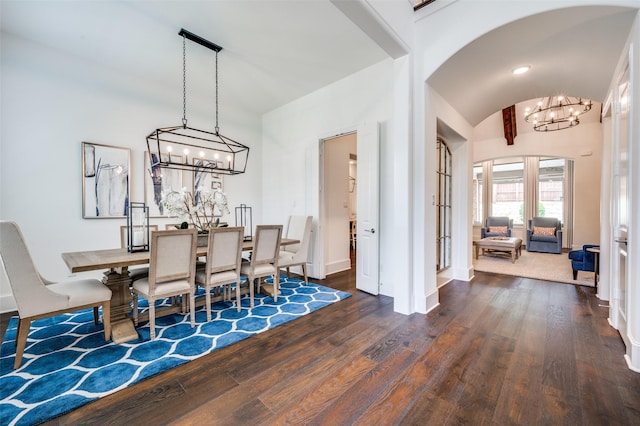 2021 Longmont Ln, Prosper, TX 75078 - dining room featuring a chandelier, arched walkways, wood-type flooring, vaulted ceiling, and baseboards
