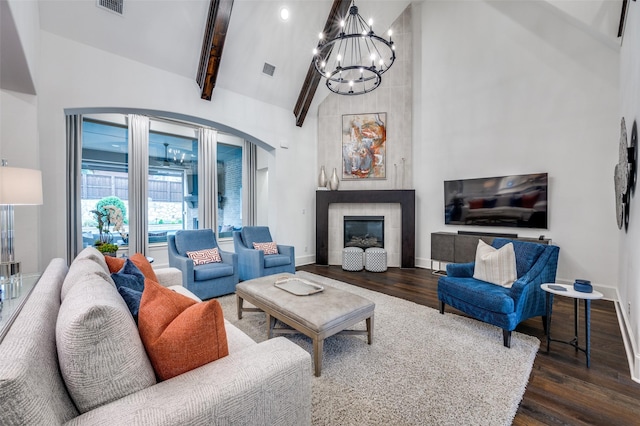 2021 Longmont Ln, Prosper, TX 75078 - living area with dark wood-type flooring, high vaulted ceiling, arched walkways, a chandelier, and baseboards