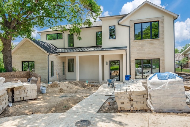 7163 Lyre Ln, Dallas, TX 75214 - view of front of home with a standing seam roof, a porch, and stone siding