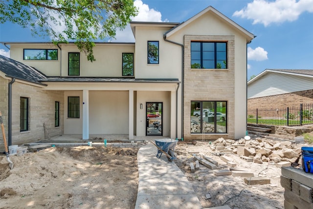7163 Lyre Ln, Dallas, TX 75214 - contemporary home featuring stucco siding, a standing seam roof, metal roof, and covered porch