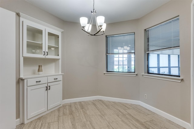5004 Andover Dr, Plano, TX 75023 - unfurnished dining area with a chandelier and light wood-style flooring