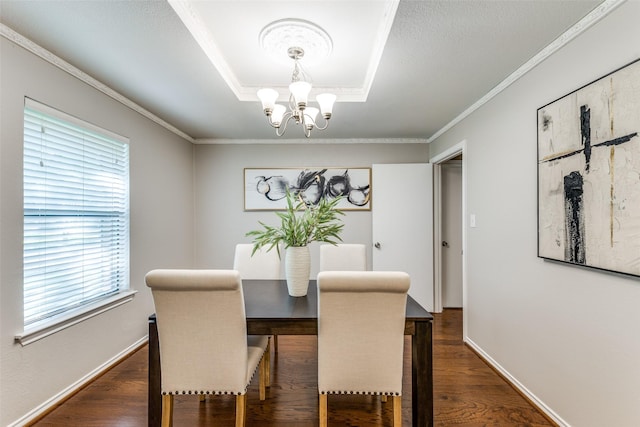 5004 Andover Dr, Plano, TX 75023 - dining area with a chandelier, a tray ceiling, dark wood-type flooring, and crown molding