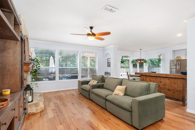 933 Oatlands Pl, Burleson, TX 76028 - living room featuring a ceiling fan, light wood-style floors, baseboards, crown molding, and a chandelier