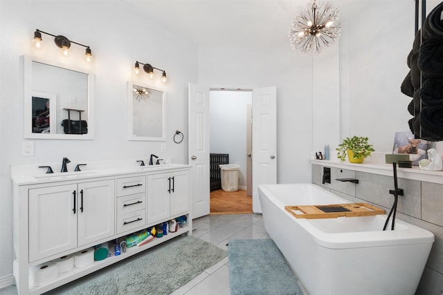 933 Oatlands Pl, Burleson, TX 76028 - full bathroom featuring double vanity, a soaking tub, tile patterned floors, and a chandelier