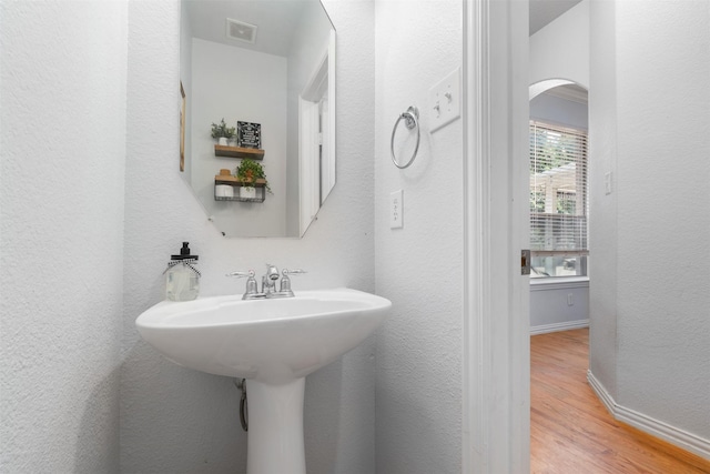 933 Oatlands Pl, Burleson, TX 76028 - bathroom with wood finished floors, baseboards, and a textured wall