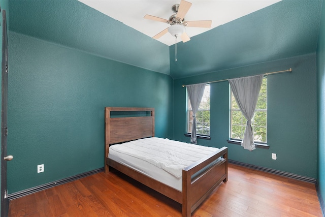 933 Oatlands Pl, Burleson, TX 76028 - bedroom with wood finished floors, vaulted ceiling, baseboards, and a ceiling fan