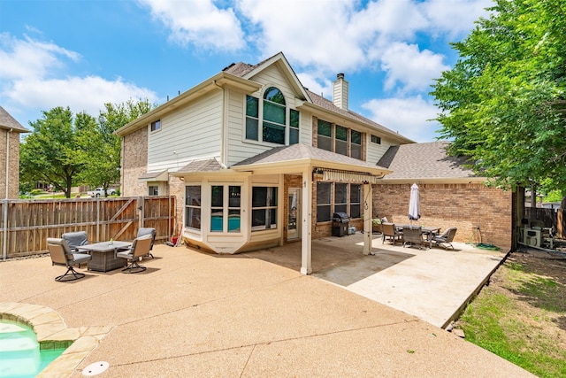 933 Oatlands Pl, Burleson, TX 76028 - rear view of house with an outdoor fire pit, brick siding, a chimney, a patio area, and a fenced backyard