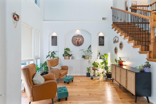 933 Oatlands Pl, Burleson, TX 76028 - sitting room with a high ceiling, stairs, light wood-type flooring, and baseboards