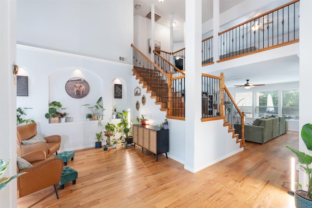 933 Oatlands Pl, Burleson, TX 76028 - stairway featuring a towering ceiling, wood finished floors, ceiling fan, and baseboards