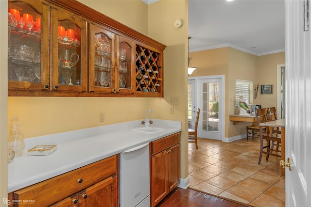 5705 Lake Side Dr, Bossier City, LA 71111 - kitchen with a sink, glass insert cabinets, crown molding, light countertops, and brown cabinetry