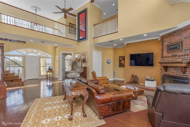 5705 Lake Side Dr, Bossier City, LA 71111 - living room with wood finished floors, baseboards, ornamental molding, stairway, and a fireplace
