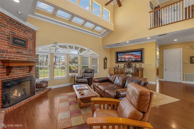 5705 Lake Side Dr, Bossier City, LA 71111 - living area featuring a fireplace, a high ceiling, hardwood / wood-style floors, baseboards, and crown molding