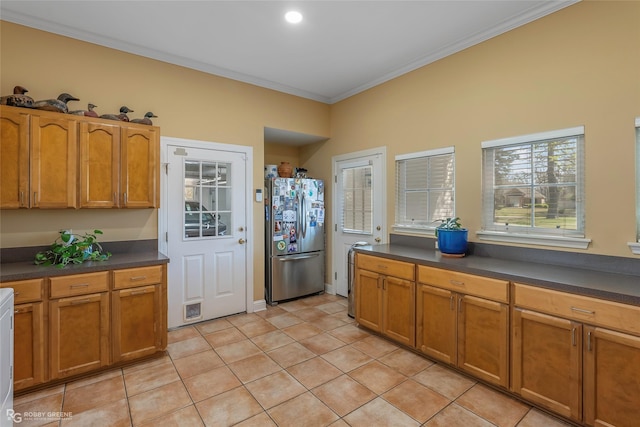 5705 Lake Side Dr, Bossier City, LA 71111 - kitchen featuring freestanding refrigerator, dark countertops, ornamental molding, and light tile patterned flooring