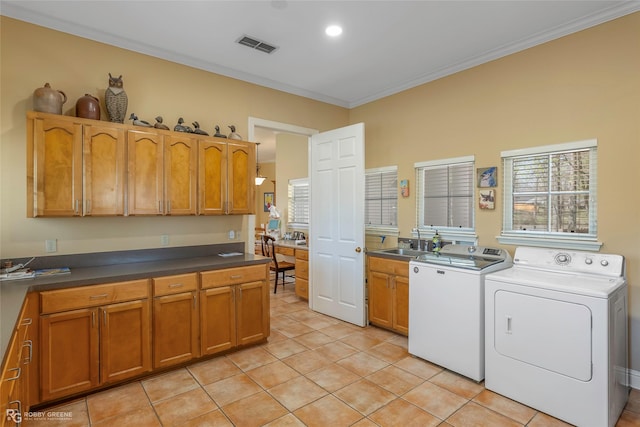 5705 Lake Side Dr, Bossier City, LA 71111 - laundry room with washer and dryer, cabinet space, light tile patterned floors, crown molding, and healthy amount of natural light