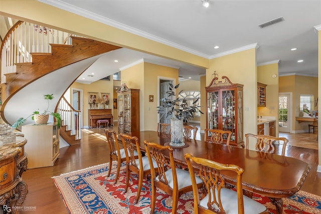 5705 Lake Side Dr, Bossier City, LA 71111 - dining space with stairway, wood finished floors, recessed lighting, ornamental molding, and baseboards