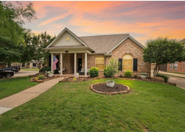 2541 Sir Tristram Ln, Lewisville, TX 75056 - view of front facade featuring brick siding, a yard, and a shingled roof