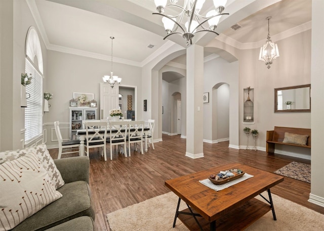 2541 Sir Tristram Ln, Lewisville, TX 75056 - living room with a chandelier, arched walkways, wood finished floors, and crown molding