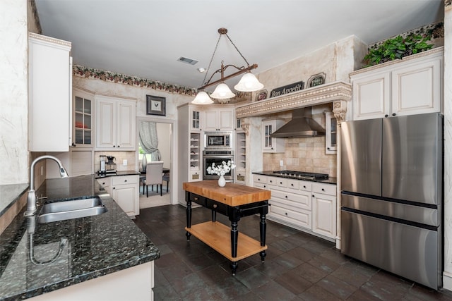 3873 Heritage Trl, Celina, TX 75009 - kitchen featuring stainless steel appliances, wall chimney range hood, a sink, and glass insert cabinets