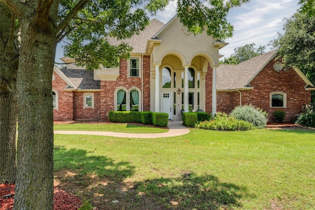 3873 Heritage Trl, Celina, TX 75009 - view of front of home with a shingled roof, a front yard, and brick siding