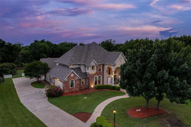 3873 Heritage Trl, Celina, TX 75009 - french provincial home featuring concrete driveway, brick siding, stucco siding, and roof with shingles