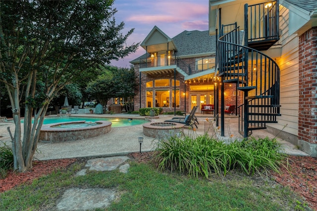 3873 Heritage Trl, Celina, TX 75009 - back of property featuring a balcony, a patio, brick siding, and a pool with connected hot tub
