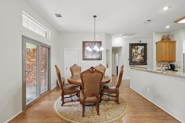 8217 Alderwood Pl, Plano, TX 75025 - dining area featuring light wood-style floors, a chandelier, and recessed lighting