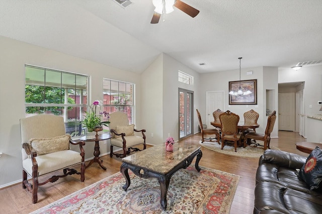 8217 Alderwood Pl, Plano, TX 75025 - living area featuring light wood-style flooring, ceiling fan, a chandelier, a textured ceiling, and lofted ceiling