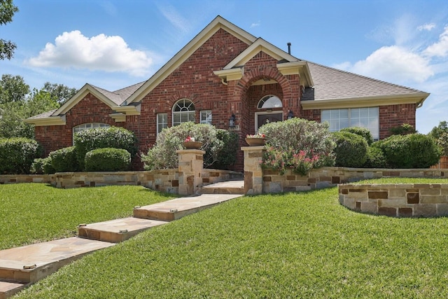 8217 Alderwood Pl, Plano, TX 75025 - traditional-style home with brick siding, a front lawn, and a shingled roof