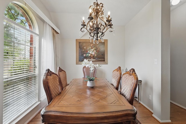 8217 Alderwood Pl, Plano, TX 75025 - dining room with a chandelier, wood finished floors, vaulted ceiling, and baseboards